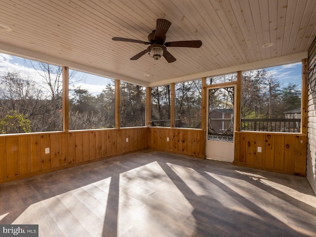 unfurnished sunroom featuring ceiling fan and wood ceiling