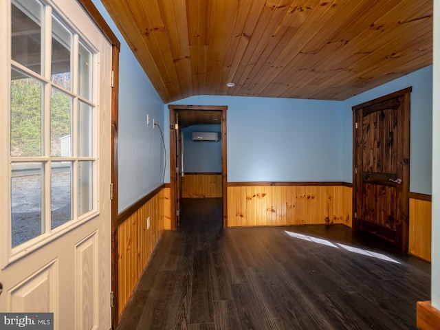 empty room with wood walls, a wall mounted AC, wood ceiling, lofted ceiling, and dark hardwood / wood-style flooring