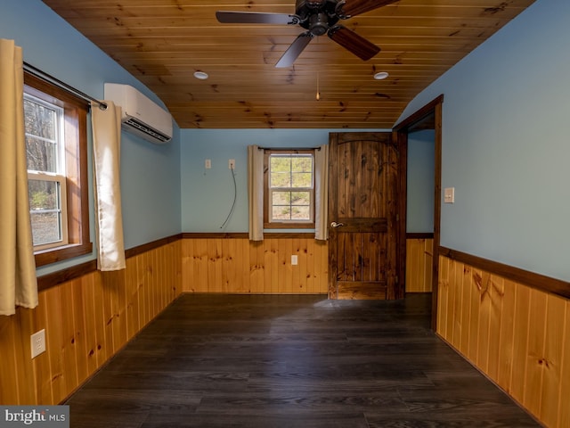 empty room featuring dark wood-type flooring, wooden walls, an AC wall unit, and wooden ceiling