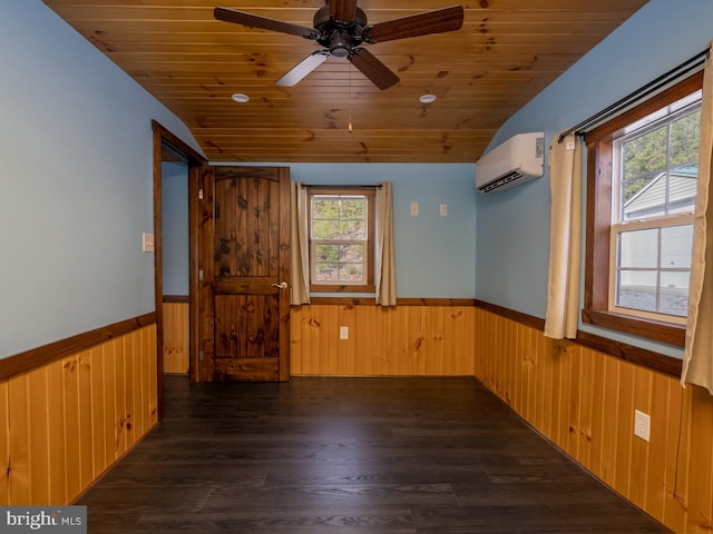 empty room featuring dark wood-type flooring, wooden ceiling, vaulted ceiling, and a wall mounted air conditioner