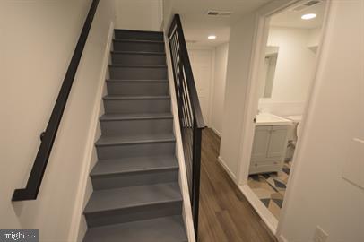 stairs featuring wood-type flooring