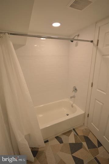 bathroom with shower / bathtub combination with curtain