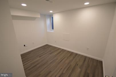 basement featuring dark hardwood / wood-style floors