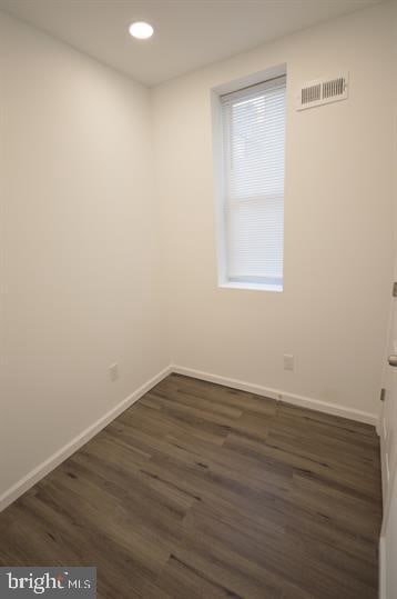 unfurnished room featuring dark hardwood / wood-style flooring