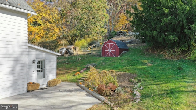 view of yard featuring a storage unit and a patio area