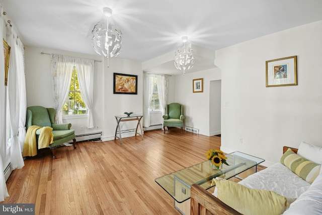 interior space with a wealth of natural light, a chandelier, and hardwood / wood-style flooring