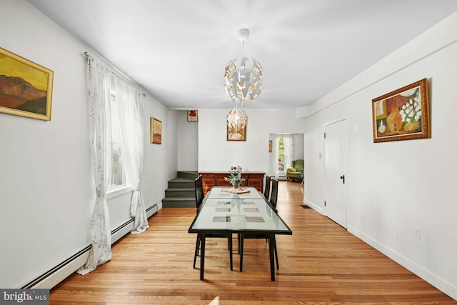 dining space with an inviting chandelier, a healthy amount of sunlight, and light wood-type flooring