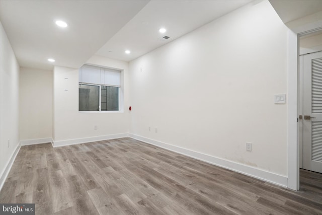 unfurnished room with light wood-type flooring