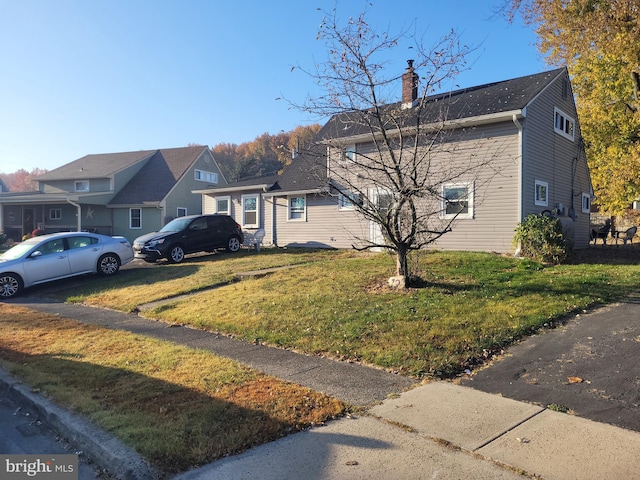 view of side of property with a lawn