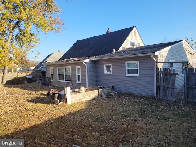 back of property featuring a yard