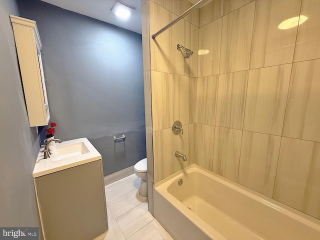 full bathroom with toilet, tiled shower / bath combo, vanity, and tile patterned floors