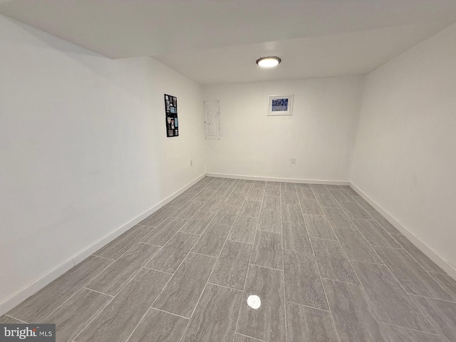 empty room featuring electric panel and light wood-type flooring