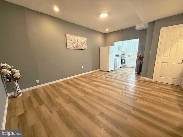 interior space with light hardwood / wood-style floors and a textured ceiling