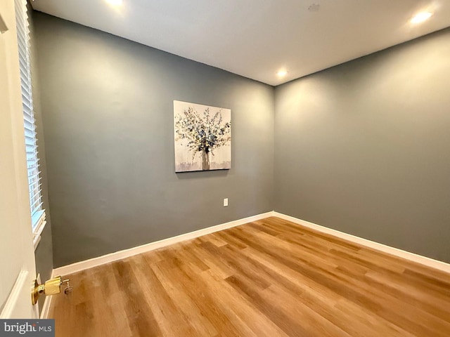 empty room with hardwood / wood-style flooring