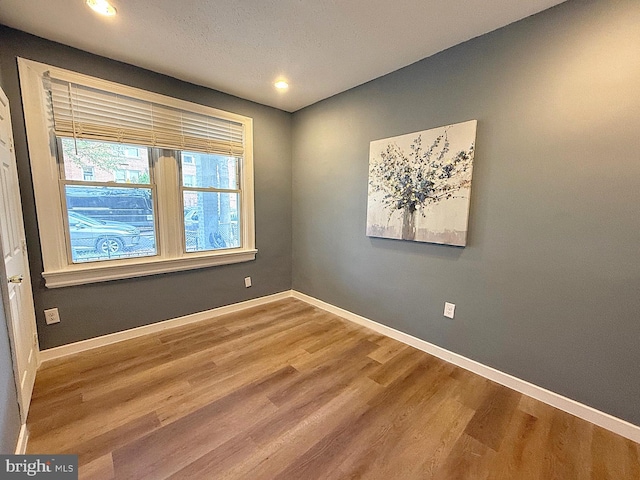 empty room with hardwood / wood-style floors