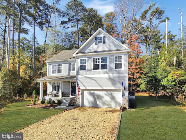 view of front of home with a front lawn, a garage, and covered porch