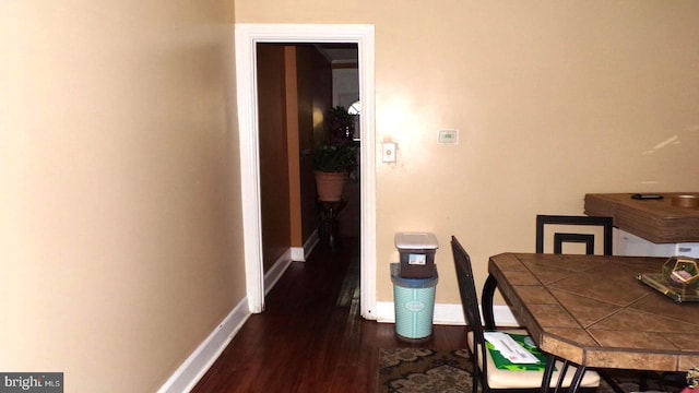 dining area with dark hardwood / wood-style flooring