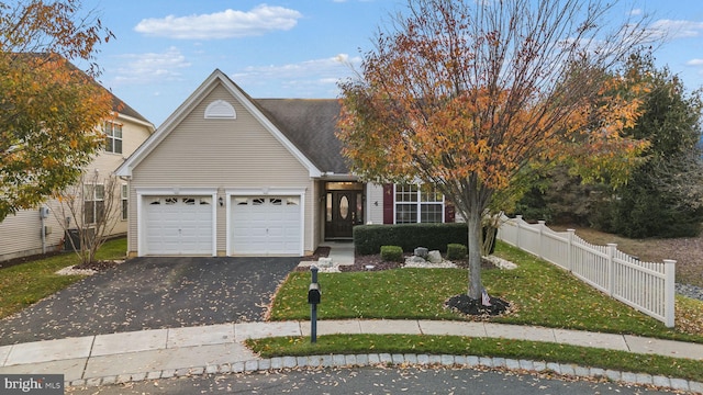 obstructed view of property featuring a garage and a front lawn