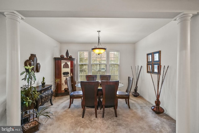 carpeted dining area with ornate columns