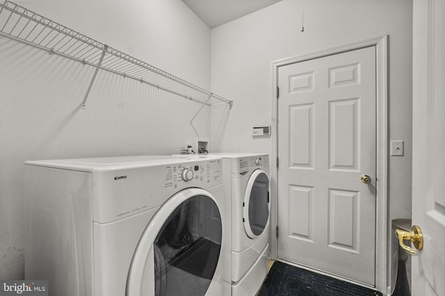 clothes washing area featuring washer and dryer