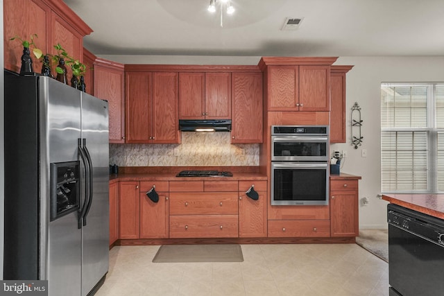 kitchen featuring black appliances and backsplash