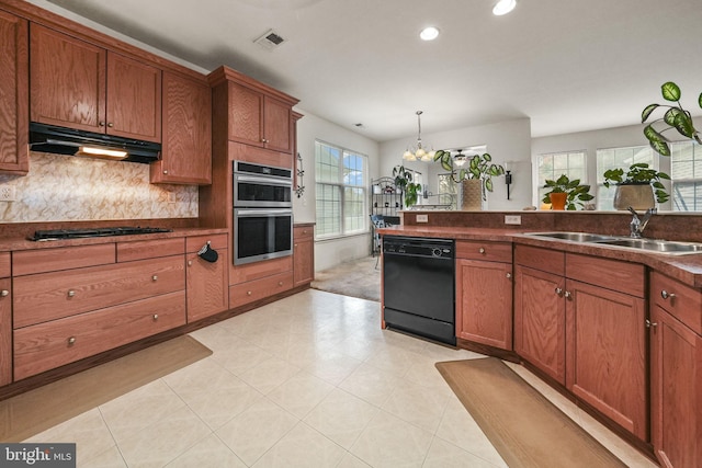 kitchen featuring gas cooktop, an inviting chandelier, sink, dishwasher, and double oven