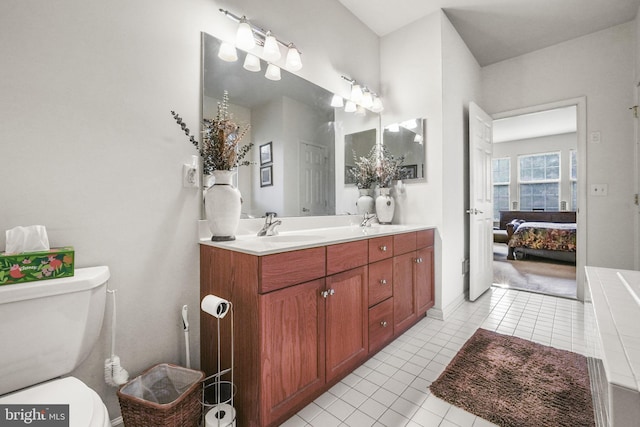 bathroom with tile patterned flooring, vanity, and toilet