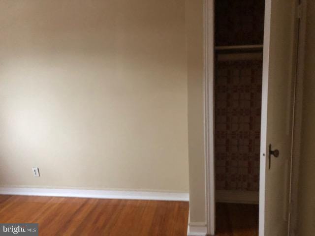 unfurnished bedroom with hardwood / wood-style flooring and a closet