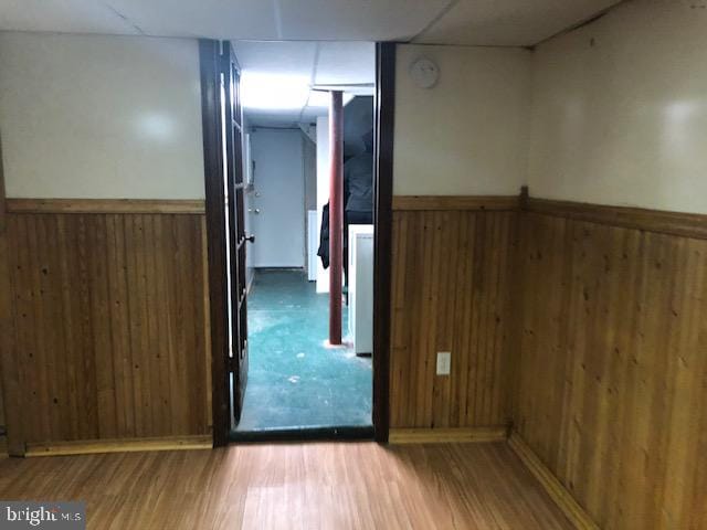 empty room featuring hardwood / wood-style flooring and wood walls