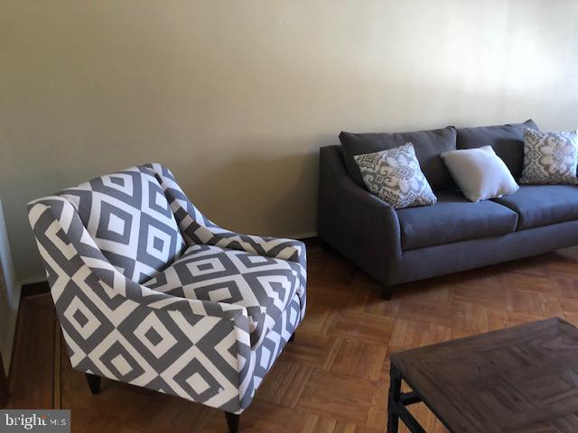 living room featuring dark parquet floors