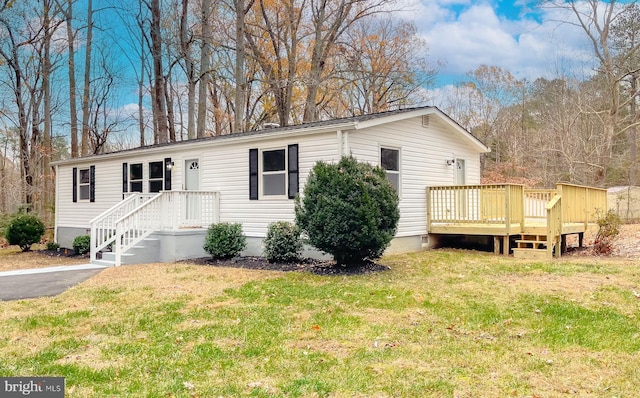 view of front of home featuring a front yard and a deck