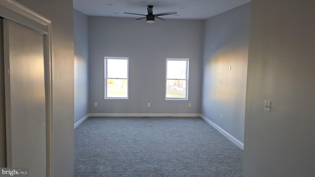 spare room featuring carpet flooring and ceiling fan