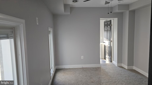 carpeted spare room with ceiling fan