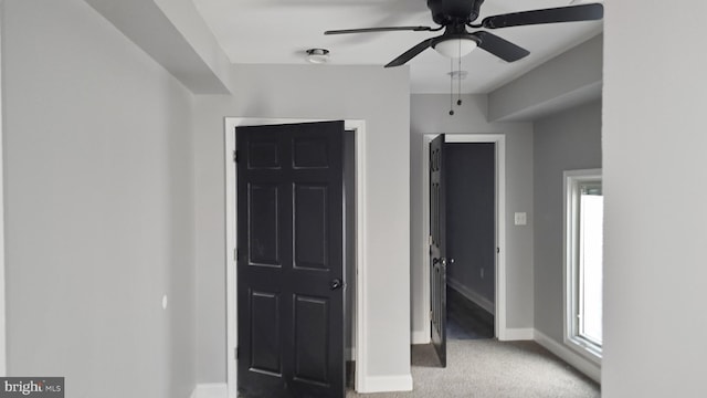 unfurnished bedroom featuring light colored carpet and ceiling fan