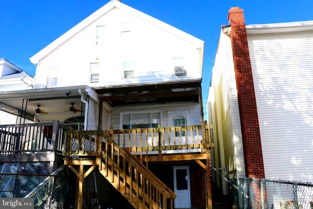 back of property with ceiling fan