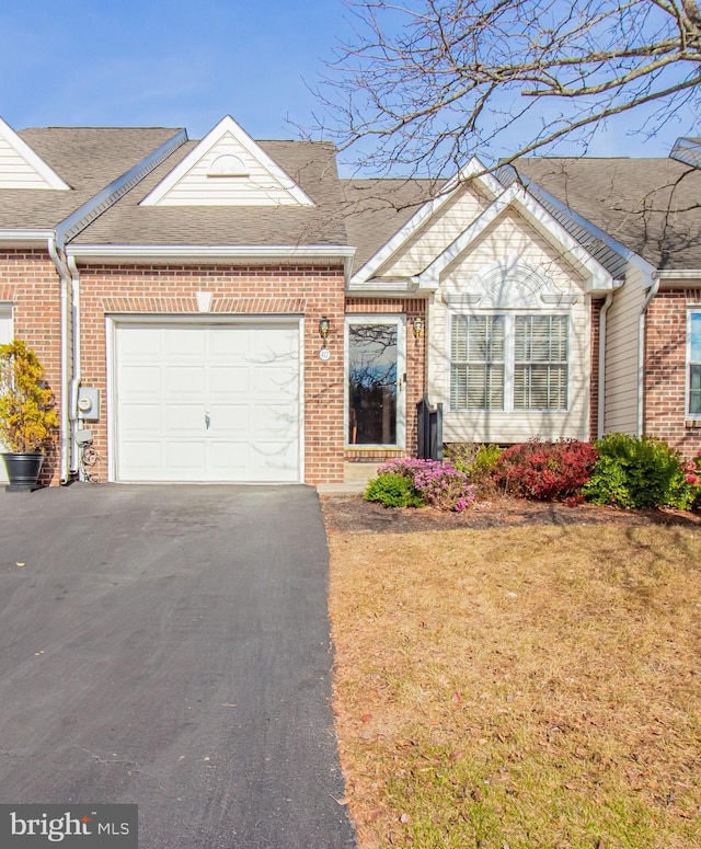 single story home featuring a front lawn and a garage