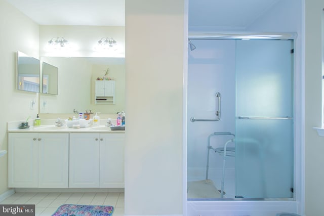 417 E Red Lion Dr, Bear, DE 19701 - bathroom featuring tile patterned floors, a shower stall, double vanity, and baseboards