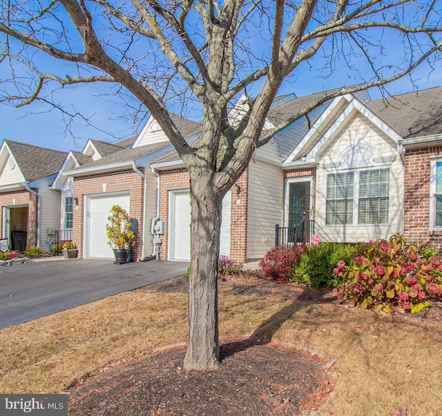 417 E Red Lion Dr, Bear, DE 19701 - view of front facade featuring a garage, driveway, and brick siding
