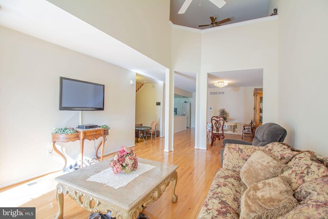 417 E Red Lion Dr, Bear, DE 19701 - living area featuring ceiling fan, light wood finished floors, a high ceiling, and ornamental molding