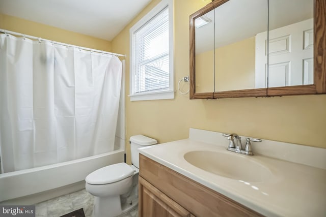 full bathroom featuring vanity, shower / bath combo with shower curtain, and toilet