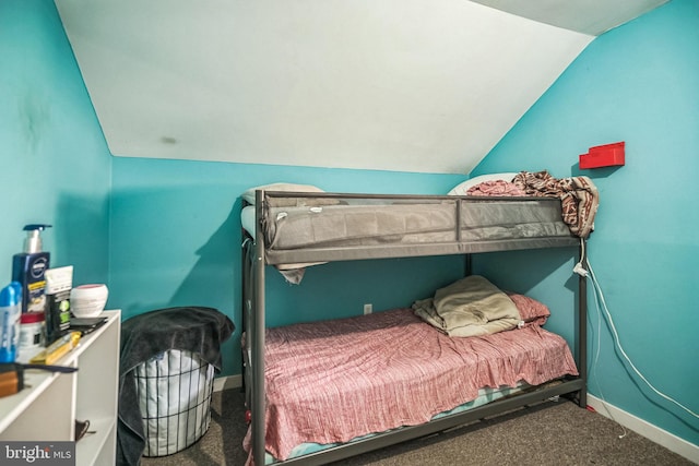 carpeted bedroom with vaulted ceiling