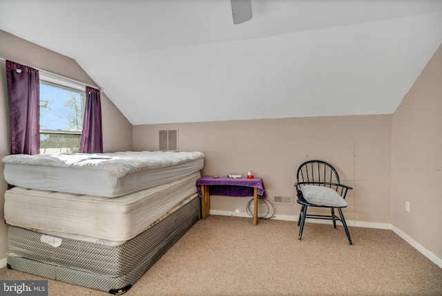 carpeted bedroom with ceiling fan and vaulted ceiling