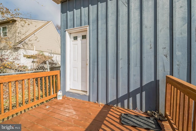 view of exterior entry with a wooden deck