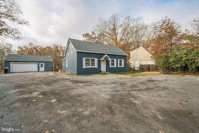 view of front of home with a garage and an outdoor structure