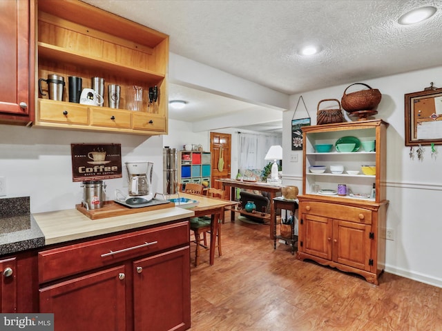 kitchen featuring light hardwood / wood-style flooring and a textured ceiling