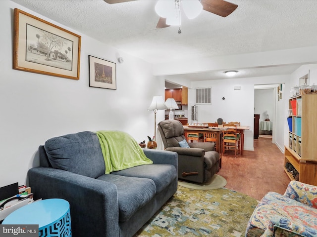 living room featuring a textured ceiling and light hardwood / wood-style flooring