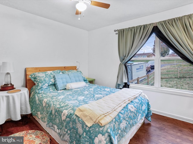 bedroom with ceiling fan and dark hardwood / wood-style flooring