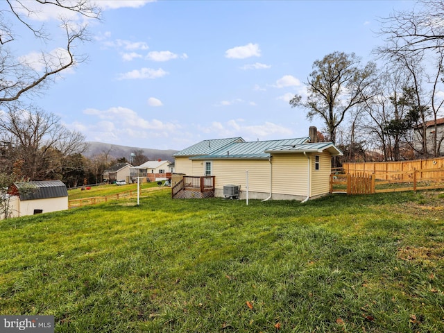 view of yard with cooling unit and a deck with mountain view