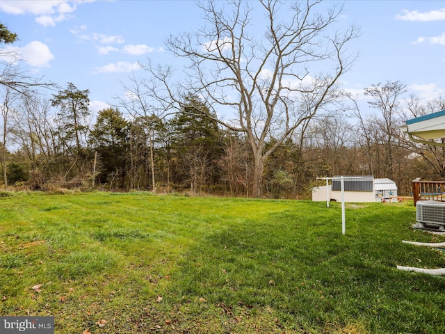 view of yard with an outdoor structure and central AC