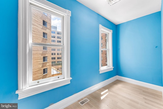 spare room with light hardwood / wood-style flooring